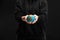 Partial view of woman holding plasticine globe isolated on black, global warming concept