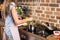 partial view of woman preparing pepper for dinner in kitchen