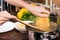 partial view of woman preparing pepper for dinner in kitchen