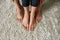 Partial of women barefoot legs on terry carpet