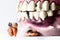 Partial wooden dentures and real tooth with caries and cavities. Dental Health care