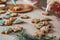 Partially blurred kids decorated gingerbread cookies with blue and white icing on wooden table. Children prepare cookies