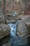 Partially frozen creek flowing the mountains