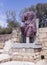 Partially preserved statue of pink marble in the ruined city of