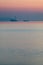 Partially sunken ship in after sunset haze