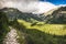 Partially Sunlit Valley with Hiking Trail and Peaks of Mountains