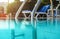 Partially underwater photo, steel handrails at entry to swimming pool, backlight sun shining in background. Vacation / relax image