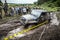 Participant on Jeep passes a deep muddy pit.