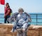 A participant of the Purim festival dressed as a statue sitting in a column in Caesarea, Israel