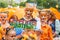 Participants of annual festive Tiger Day. Kids hold tiger drawing with the inscription `Take care of animals.`