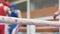 Participants in boxing competitions. Boxing match in ring between men in protective uniform. Fight is held under