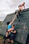 Participants in obstacle course climbing pyramid obstacle