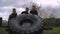 Participants in an obstacle course turning a wheel