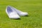 Particular of white wedding shoes on grass