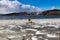 Partly frozen lake with buoys in ice