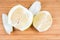 Partly peeled ripe pomelo on a wooden cutting board