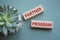 Partner Program symbol. Wooden blocks with words Partner Program. Beautiful grey green background with succulent plant. Business