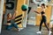 Partner workout. Two young athletic women in sportswear exercising with ball at gym