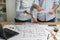 Partners partnership concept. Cropped two designer person in formal wear shirt at workstation table with measurement compass