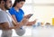 Partners Using Phone While Eating Breakfast Together