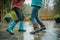 partners in waterproof boots do a jitterbug on a wet patio