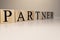 Partners word written on wood block. Partners text on wooden table