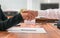 Partnership concept. Businessman and woman sitting behind desk with agreement