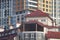 Parts of the facades of buildings with reflections of the sky with clouds and the sun.