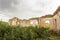 Parts of a ruined house with dramatic sky - different textures and herbs