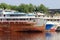 Parts of rusty cargo ships and lowered anchors on river