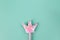 Party accessory, fairy wand. Pastel turquoise background, copy space. Holiday festive flat lay. Minimal style. Horizontal