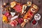 Party appetizers boards with assorted cheeses, meats and crostini, top view on wood