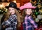 Party is on. Christmas party concept. Girls sisters carnival hats costumes new year party. Kids friends celebrate winter