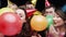 Party, confetti and people with balloons in studio for festive celebration, social event and birthday on black