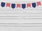 Party flags on wooden background. 4th July, Independence day, card, invitation in usa flag colors. Top view, empty space.