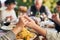 Party, food and family holding hands for prayer before eating chicken, barbecue or turkey at a social event. Corn