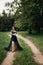 Party graduation prom fairytale concept. Beautiful brunette young woman in blue prom dress on nature background. Outdoor