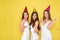 Party and holidays concept. Three glamour women in luxury glitter sequins dress dancing and having fun with confetti and