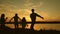 Party by the lake, children dad and mom dance. happy family dancing on the beach. happy girls dancing on beach. Slow