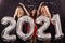 Party, people and new year holidays concept - cheerful young women celebrating new years eve 2021