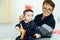 Party, Purim. Senior woman having fun with grandson, holding funny crown on a stick