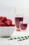 Party with strawberries and juice. Light juice background with straw.