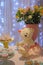 Party table, candies, homemade dessert, lovely details. Front view picture. Bokeh lights background. Teddy bear
