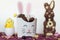 Party treat box with edible easter eggs, decorative chick and chocolate bunny on decorated table