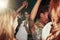 Party women and dance at nightclub rave with glow sticks for cheerful fun, youth and celebration. Interracial, event and