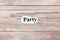 PARTY of the word on paper. concept. Words of PARTY on a wooden background