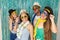 Partygoers are celebrating Carnival in Brazil. They wear sunglasses and hats..