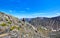 Pass hopping. Woman with a backpack on background of mountain peaks high in mountains