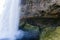 Passage behind a waterfall in the mountains