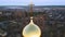 The passage of the camera next to the cross which is on the dome of the Orthodox Church